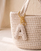 Crochet initial charm on a tote bag