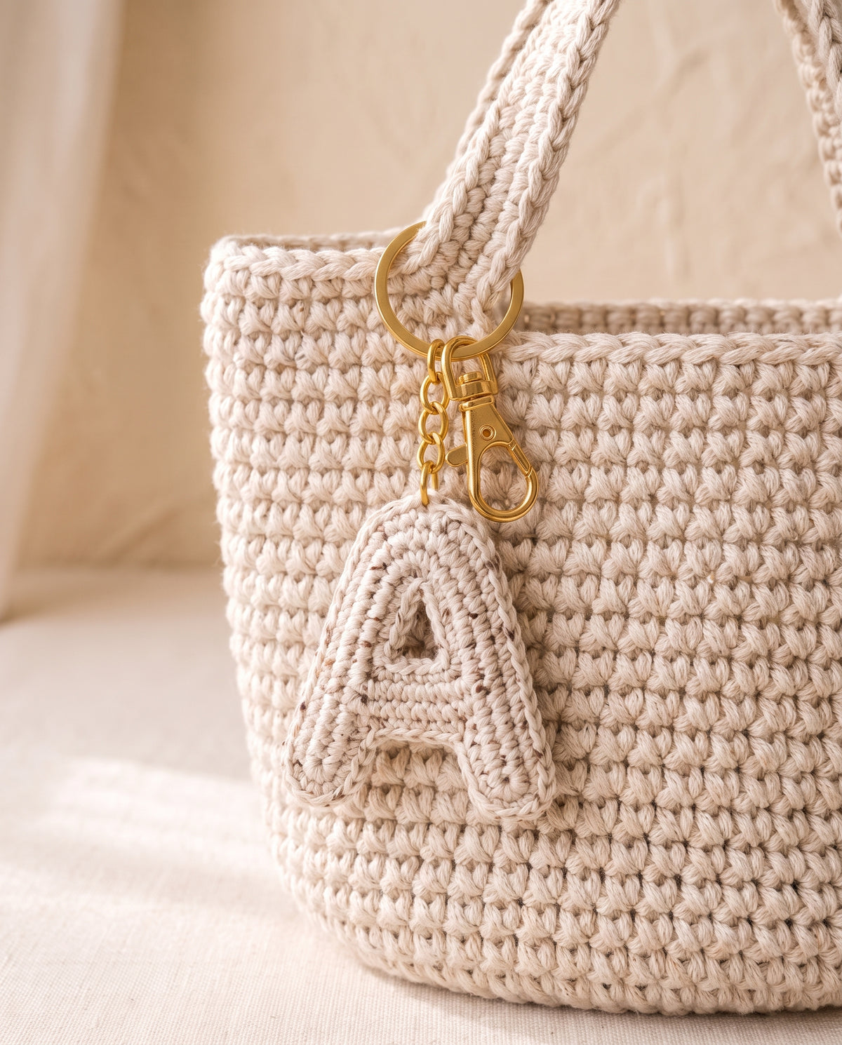 Crochet initial charm on a tote bag