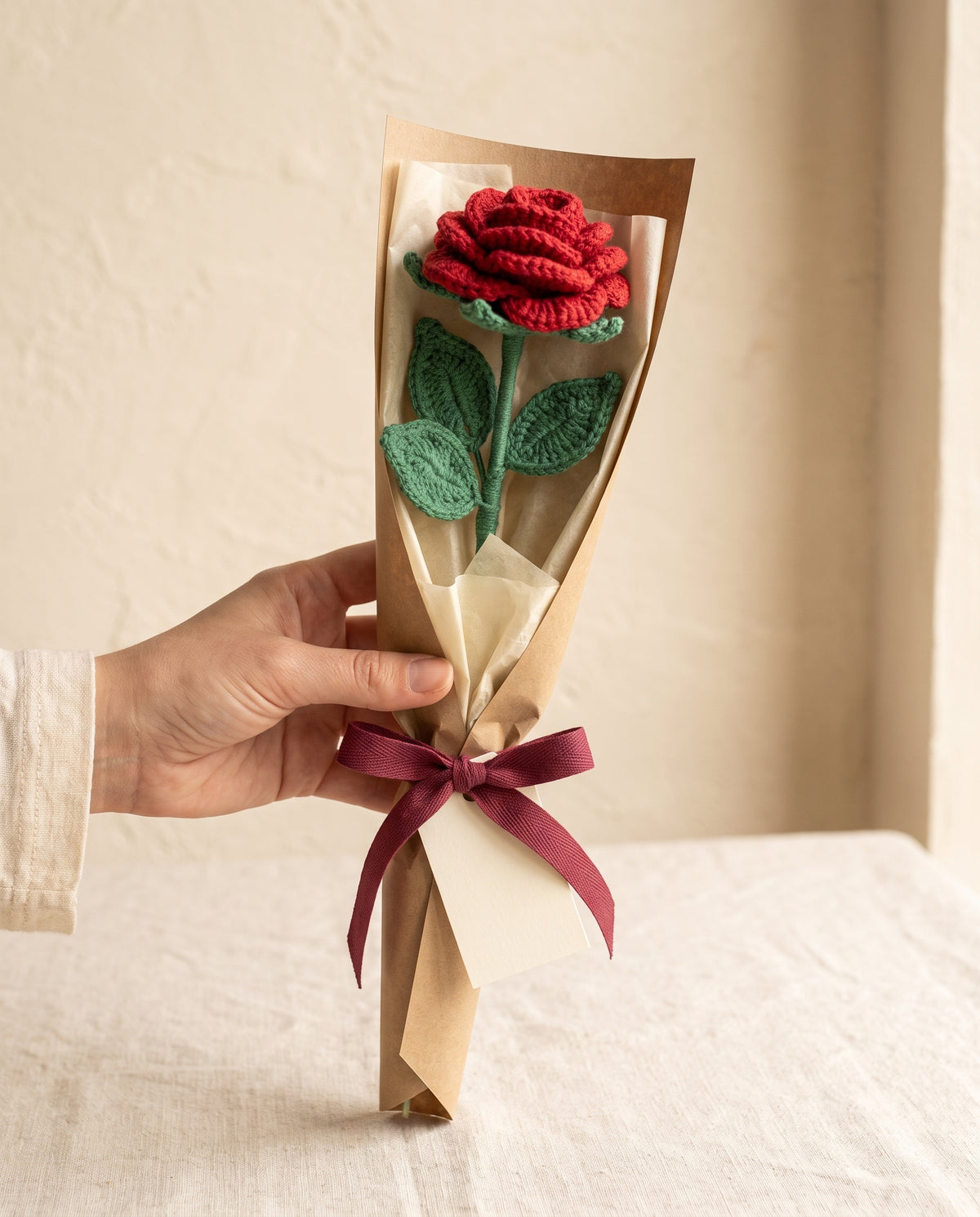 Single crochet red rose stem wrapped in kraft paper with ribbon
