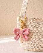 Crochet bow charm on a tote bag
