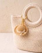 Crochet mini hat charm on a tote bag