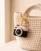 Crochet camera charm on a tote bag