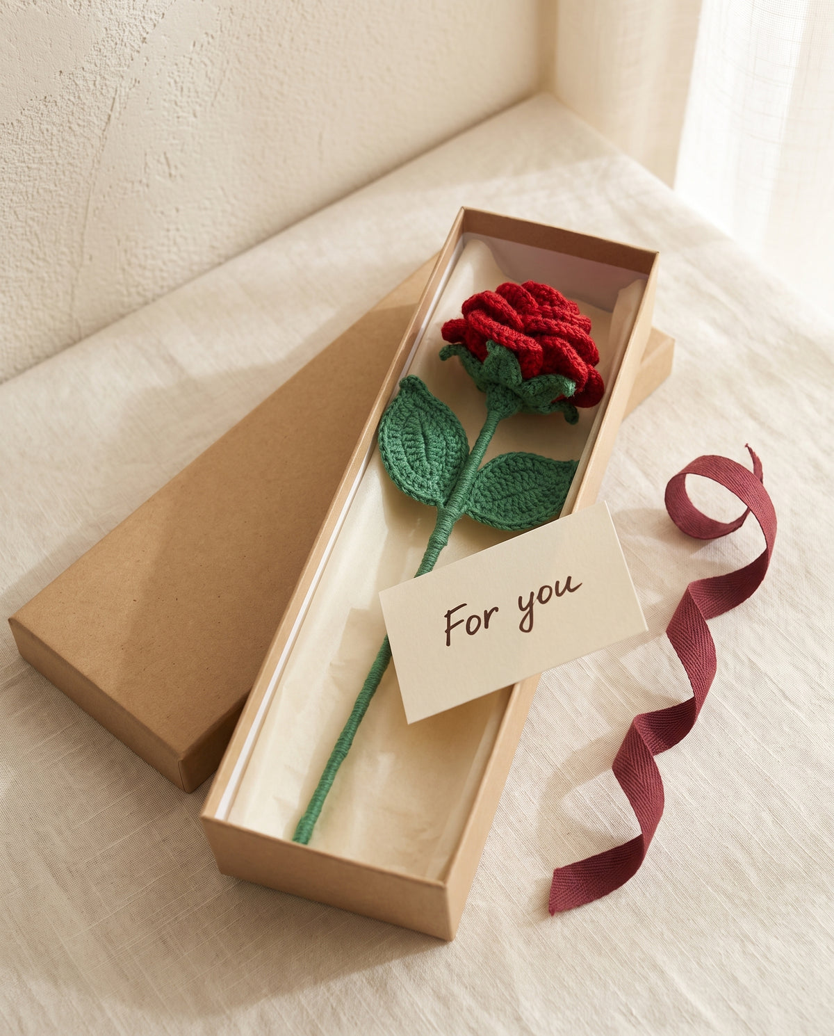 Single crochet red rose in a kraft gift box with ribbon and card