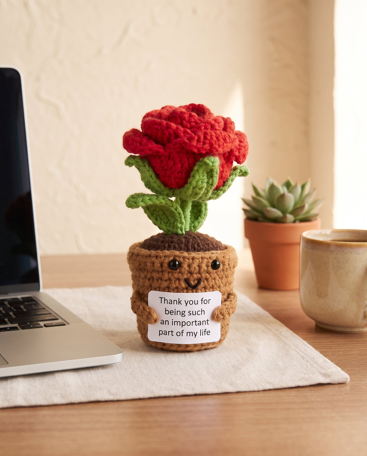 Crochet rose pot desk buddy on an office desk