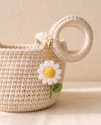 Crochet daisy charm on a tote bag