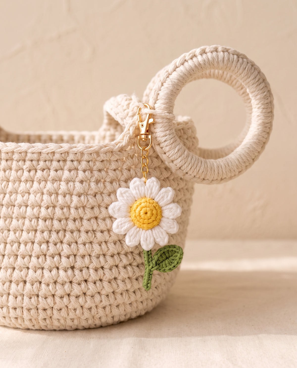 Crochet daisy charm on a tote bag