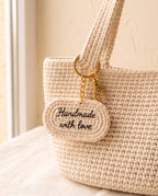 Crochet name tag charm on a tote bag