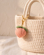 Crochet peach charm on a tote bag