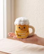 Crochet beer mug desk buddy held in a palm to show its size
