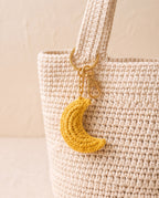 Crochet moon charm on a tote bag