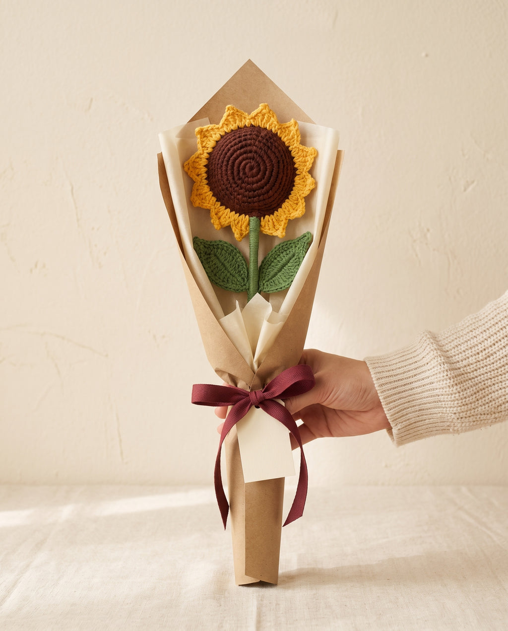 Single crochet sunflower stem wrapped in kraft paper with ribbon