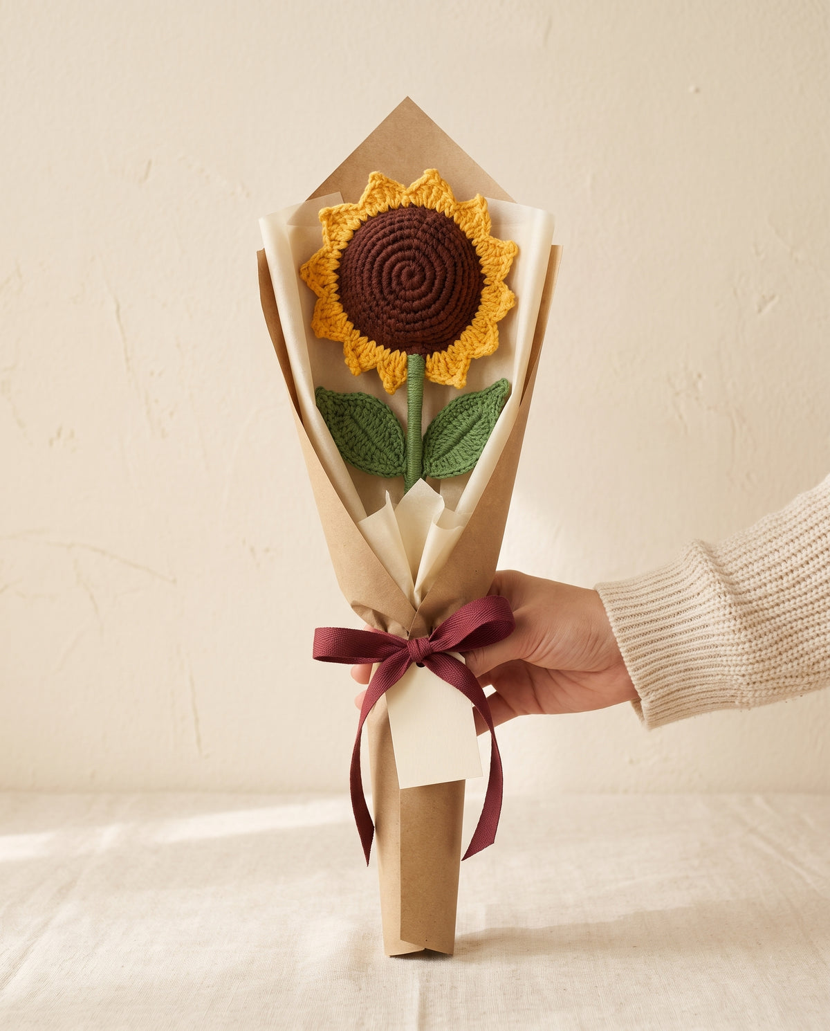 Single crochet sunflower stem wrapped in kraft paper with ribbon