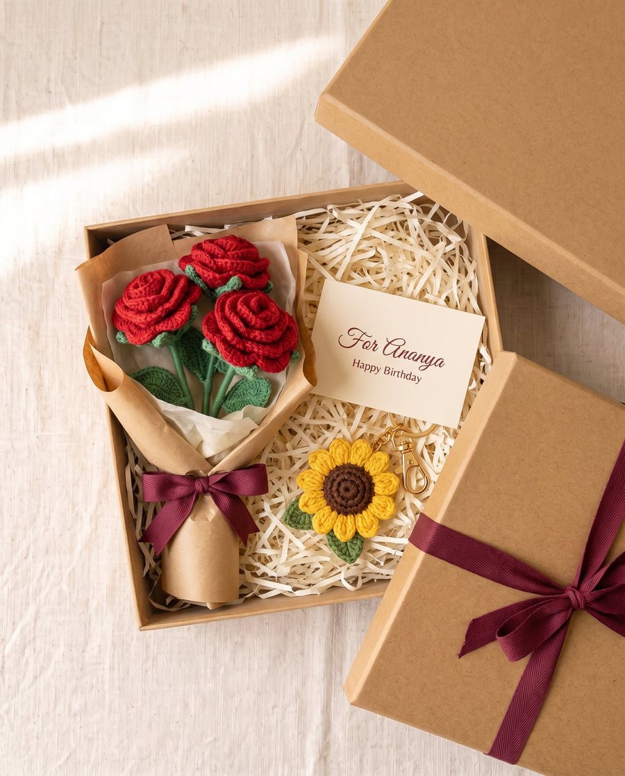 Open kraft gift box with a crochet rose bouquet, a sunflower charm and a printed name card