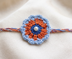 Handmade blue and orange crochet mandala rakhi with pearl centre for Raksha Bandhan