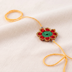 Handmade red green and gold crochet marigold flower rakhi with pearl for Raksha Bandhan