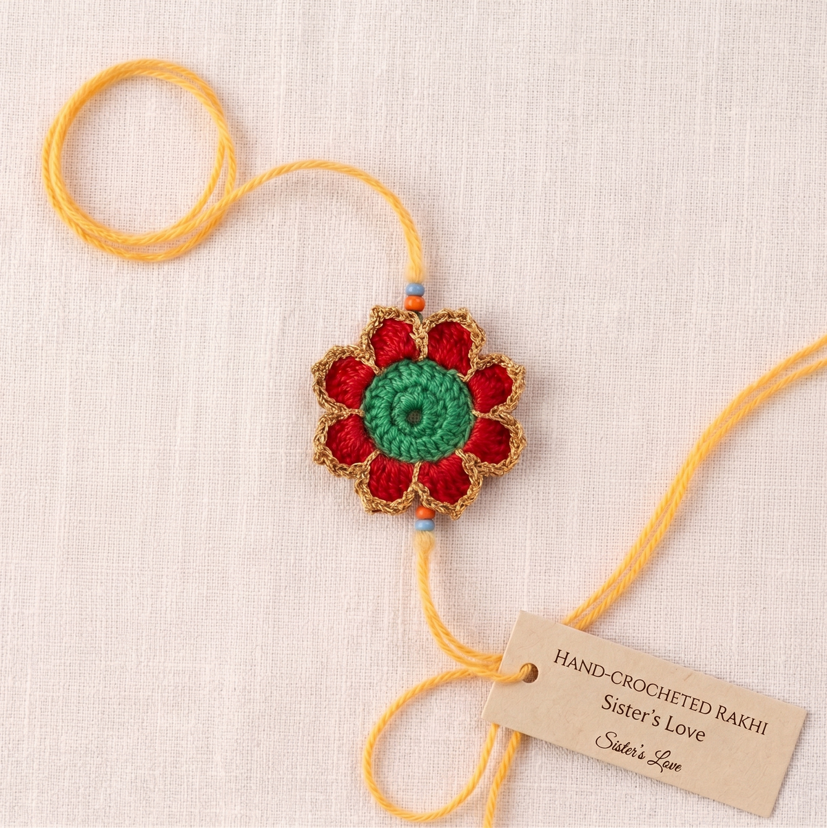 Handmade red green and gold crochet marigold flower rakhi with pearl for Raksha Bandhan
