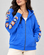 Cobalt stonewashed zip hoodie with orange and lilac hand-crocheted granny square sleeves