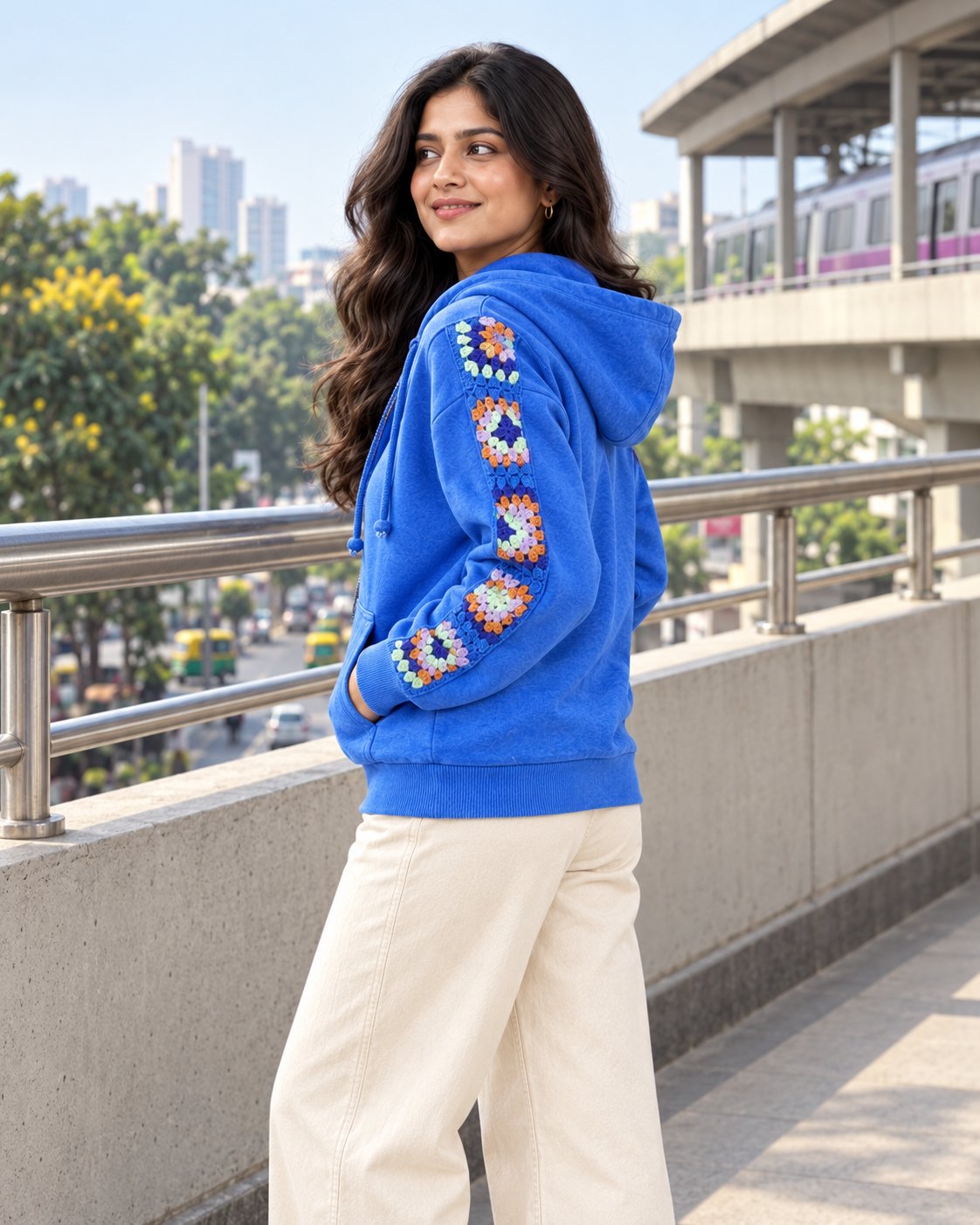 Back view of a cobalt granny square crochet zip hoodie showing the full sleeve panel